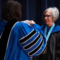 President presenting faculty an award